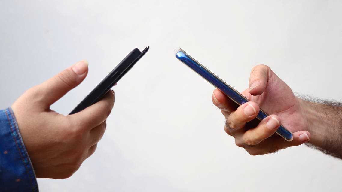 Couple using their phone at their home