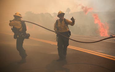 San Miguel County Firefighters battle a brush fire along Japatul Road during the Valley Fire in Jamul, California on September 6, 2020. (AFP)