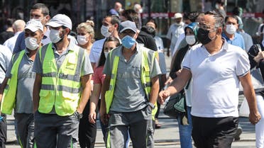 People wearing face masks walk in the street in Ankara, on September 7, 2020, amid the Covid-19 pandemic, caused by the novel coronavirus. 