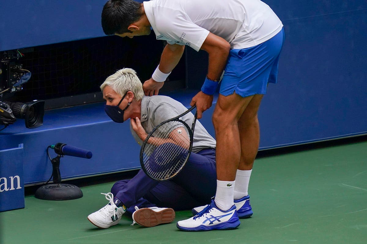 Novak Djokovic, of Serbia, checks a linesman after hitting her with a ball in reaction to losing a point to Pablo Carreno Busta, of Spain, during the fourth round of the US Open tennis championships. (AP)