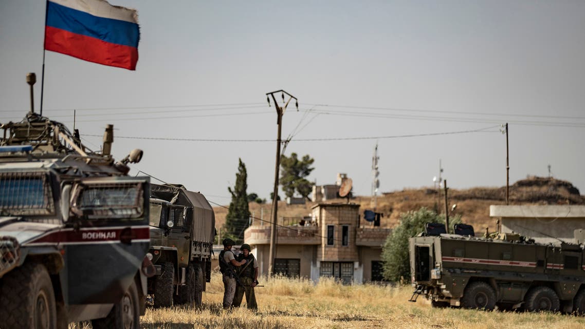 Russian soldiers reposition in the town of Derouna Arha near the Syrian border with Turkey on June 16, 2020.