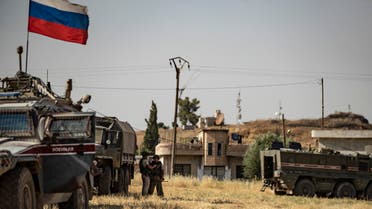 Russian soldiers reposition in the town of Derouna Arha near the Syrian border with Turkey on June 16, 2020. 