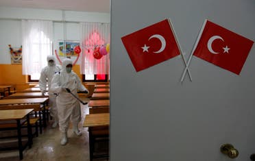 A cleaner from the Beyoglu municipality applies disinfectant to a classroom as a precaution taken in schools against the H1N1 virus at a primary school in Istanbul October 30, 2009. (Reuters/Murad Sezer)