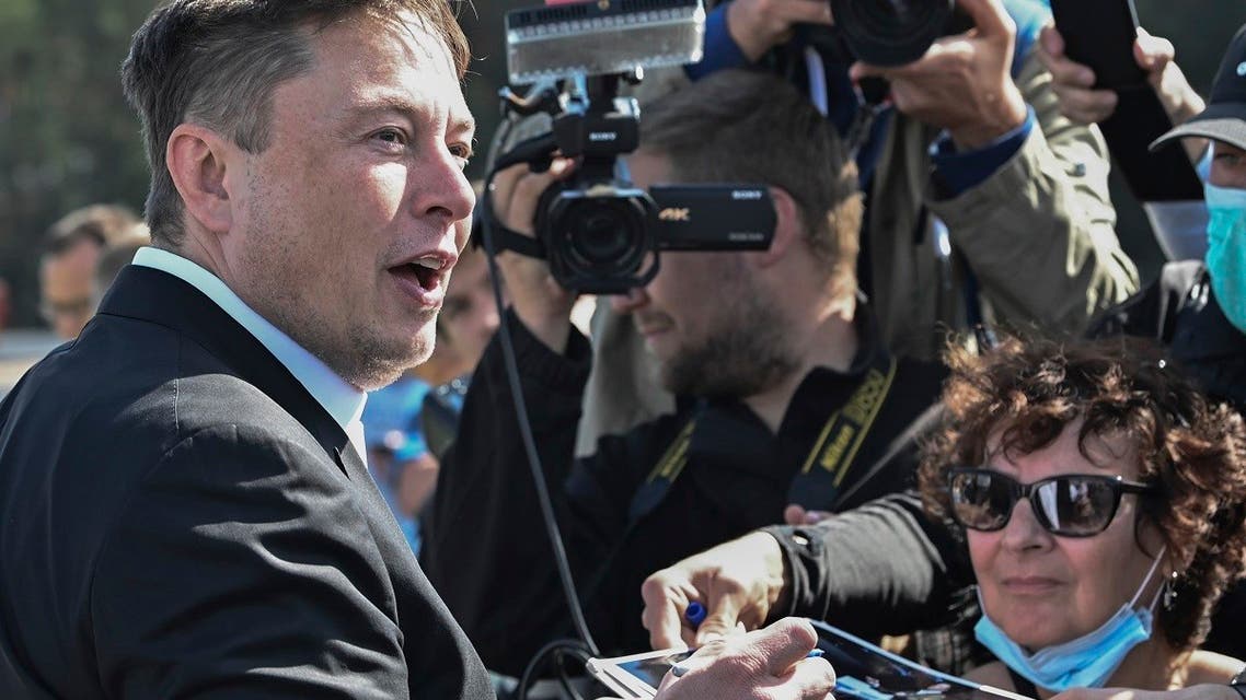 Technology entrepreneur Elon Musk gives autographs as he visits the Tesla Gigafactory construction site in Gruenheide near Berlin, Germany, on September 3, 2020. (AP)