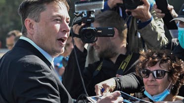 Technology entrepreneur Elon Musk gives autographs as he visits the Tesla Gigafactory construction site in Gruenheide near Berlin, Germany, on September 3, 2020. (AP)