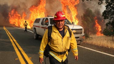 Chula Vista firefighter Rudy Diaz monitors the LNU Lightning Complex Fire as it engulfs brush in Lake County, California, US August 23, 2020. (Reuters)