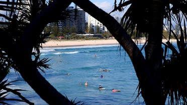 Surfers wade in the water waiting for waves off the Southern Gold Coast area of Greenmount Beach, Gold Coast. (AP)