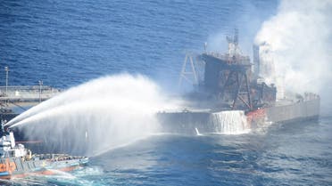 A Sri Lankan Navy boat sprays water on the New Diamond. (Reuters)