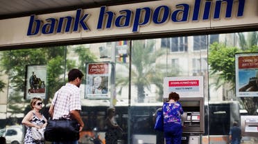 A woman uses an automated teller machine (ATM) outside a Bank Hapoalim branch in Tel Aviv, Israel May 30, 2013. (Reuters)