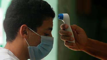 A high school student has his temperature checked before the final exams, amid concerns over the coronavirus disease (COVID-19) outbreak, in Cairo, Egypt June 21, 2020. REUTERS/Amr Abdallah Dalsh