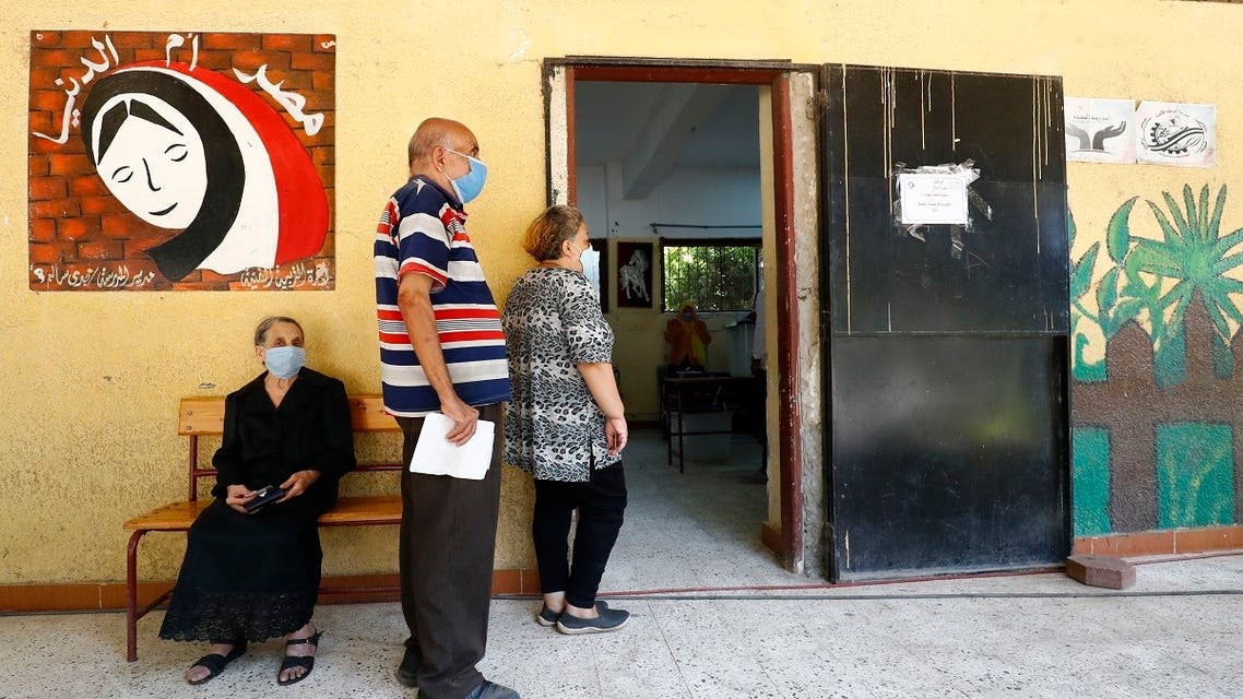 Egyptians wearing face masks against Covid-19 queue up to vote on August 11, 2020 for a new senate in an upper house election. (AFP)