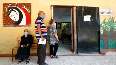 Egyptians wearing face masks against Covid-19 queue up to vote on August 11, 2020 for a new senate in an upper house election. (AFP)