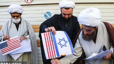 Iranian clerics burn pictures of the US and Israeli flags, in Qom, Sept. 9, 2020. (IRIB)