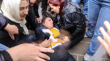 Pro-Kurdish Peoples' Democratic Party (HDP) lawmaker Remziye Tosun (C) falls after being hit by a police water cannon during a protest against results of the local elections, in Diyarbakir, on April 17, 2019. (AFP)