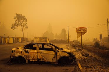 A charred vehicle is seen in the parking lot of the burned Oak Park Motel after the passage of the Santiam Fire in Gates, Oregon, on September 10, 2020. (AFP)