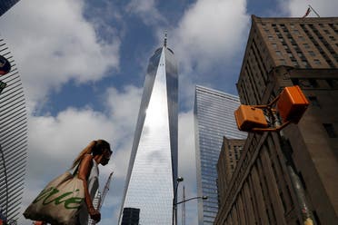 A woman wearing a protective face mask walks by One World Trade Center two days before the 19th anniversary of the 9/11 attacks, amid the coronavirus disease, in the lower section Manhattan, New York City, US, September 9, 2020. (Reuters)