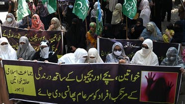 Women supporters of Pakistani Islamic political party Jamaat-e-Islami (JI) carry banners as they march during a protest against an alleged gang rape of a woman, in Lahore on September 11, 2020.  (AFP)