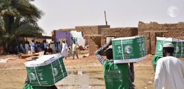 KSrelief volunteers hand out aid packages to people affected by the floods in Sudan. (Twitter)