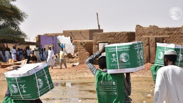 KSrelief volunteers hand out aid packages to people affected by the floods in Sudan. (Twitter)