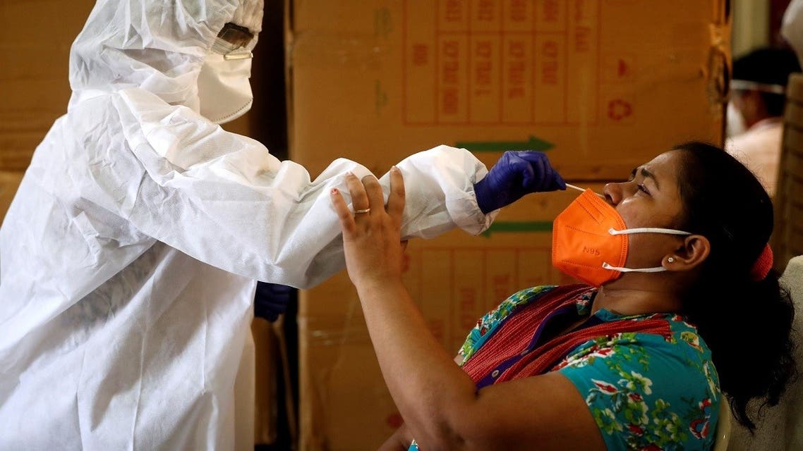2020-09-1A health worker in personal protective equipment (PPE) collects a swab sample from a woman during a rapid antigen testing campaign for the coronavirus disease (COVID-19) in Mumbai, India, September 7, 2020. REUTERS1T105423Z_1746101713_RC2AWI90TA49_RTRMADP_3_HEALTH-CORONAVIRUS-INDIA-MAHARASHTRA