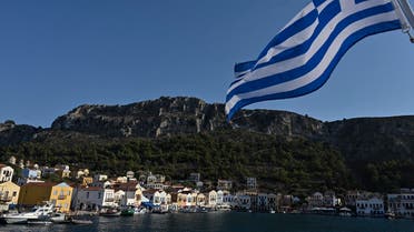 A view of the tiny Greek island of Kastellorizo (Megisti) with a Greek flag, in the Dodecanese, the furthest south eastern Greek Island, two kilometers from the Turkish mainland, on August 28, 2020. (AFP)