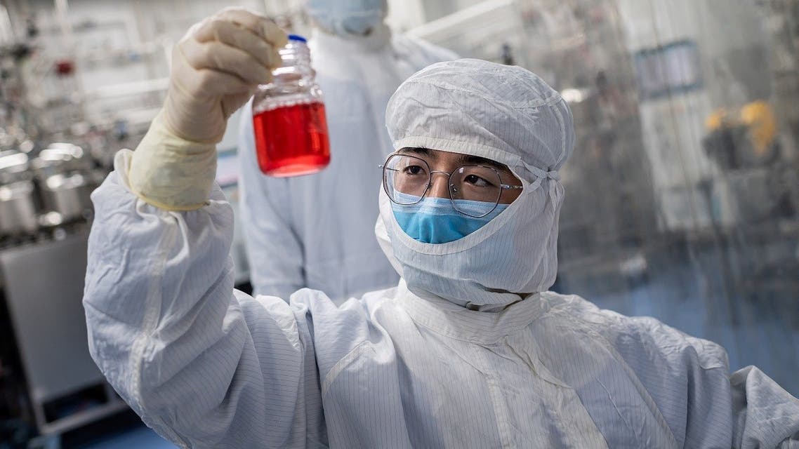 An engineer looks at monkey kidney cells as he make a test on an experimental vaccine for the COVID-19 coronavirus inside the Cells Culture Room laboratory at the Sinovac Biotech facilities in Beijing. (AFP)
