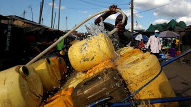 A vendor fills jerrycans with water for sale, amid a water shortage during the coronavirus disease (COVID-19) outbreak, in Nairobi, Kenya May 13, 2020. Picture taken May 13, 2020. REUTERS/Njeri Mwangi TPX IMAGES OF THE DAY