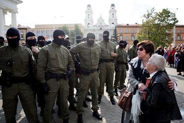 Opposition activist Nina Baginskaya (R), 73-year-old, and an unidentified woman stand in front of Belarus riot police officers during a rally in Minsk on September 12, 2020. (AFP)