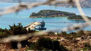 The NATO naval base of Souda is seen through barbed wire, on July 19, 2014 in Crete. Greek protesters launched a three-day blockade of the road leading to the NATO naval base of Souda, in Crete, on July 19, reacting against the destruction of Syria's chemical weapons in the Mediterranean. AFP PHOTO / STEFANOS RAPANIS