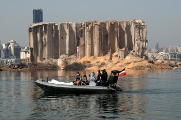 Members of the Lebanese army and the French military ride a boat past the damaged grain silo near site of the massive blast in Beirut's port area. (Reuters)