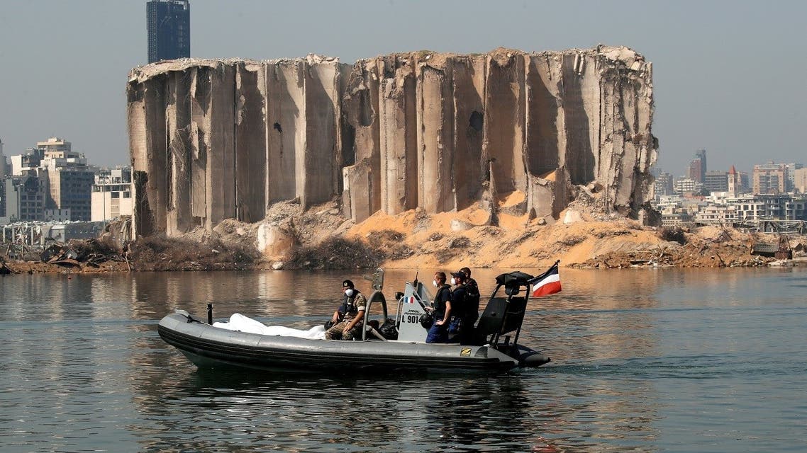 Members of the Lebanese army and the French military ride a boat past the damaged grain silo near site of the massive blast in Beirut's port area. (Reuters)
