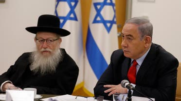 Israeli Prime Minister Benjamin Netayahu (R) and Health Minister Yaakov Litzman hold a video conference with European leaders in order to discuss challenges and cooperation between various countries in dealing with COVID-19 coronavirus, at the Foreign Ministry in Jerusalem on March 9, 2020. (AFP)
