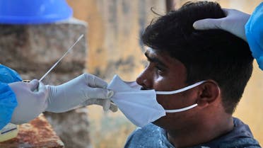 A health worker takes a nasal swab sample to test for COVID-19 in Hyderabad, India, Sunday, Sept. 13, 2020. (AP)