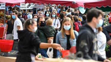People wearing face masks, to curb the spread of Covid-19, shop at a market on September 12, 2020 in Rennes, western France. (AFP)