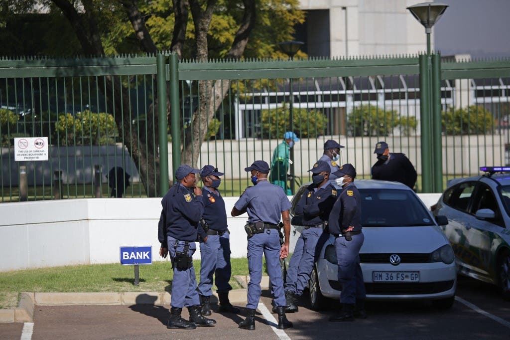 South African Police Service officers stand near their vehicles parked outside the United States (US) Embassy in Pretoria on June 3, 2020. (AFP)