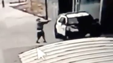 A man aims at a police vehicle in Compton, California, Sept. 12, 2020 in this still image taken from a video tweeted by the LASD. (Reuters)