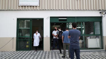 People stand in front of the Reference Center for Special Immunobiologicals where the trials of the Oxford/AstraZeneca coronavirus vaccine are conducted, Sao Paulo, Brazil, June 24, 2020. (Reuters)