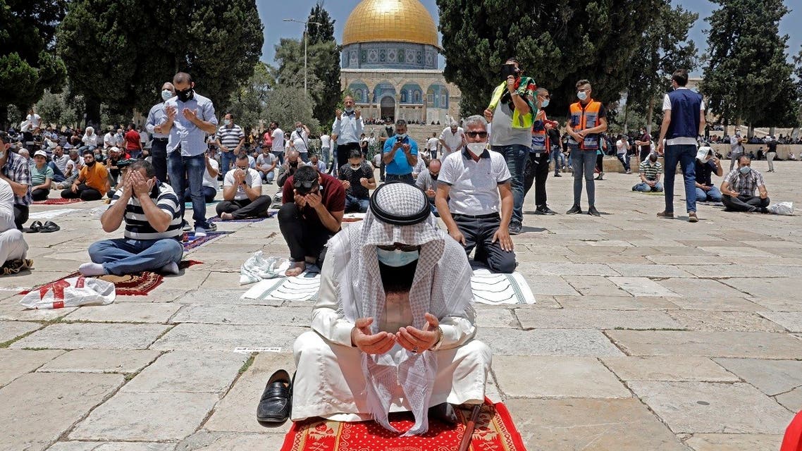 Palestinians perform the Friday prayer outside Jerusalem’s Al-Aqsa mosque compound, Islam’s third holiest site, amid the novel coronavirus pandemic crisis on July 10, 2020. (AFP)