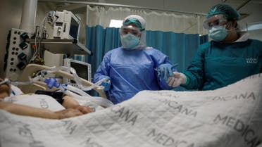 A nurse and a doctor take care of a patient suffering from the coronavirus disease (COVID-19) at an intensive care unit of the Medicana International Hospital in Istanbul, Turkey, April 14, 2020. Picture taken April 14, 2020. (Reuters/Umit Bektas)
