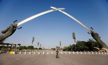 An Iraqi security officer walks near the Arch of Victory memorial in the Green Zone of Baghdad, Iraq on June 24, 2019. (Reuters)
