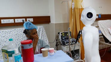 A patient suffering from the coronavirus disease speaks to his family members, using a robot named 'Mitra' at the ICUof the Yatharth Super Speciality Hospital in Noida, on the outskirts of New Delhi, India, on September 15, 2020. (Reuters)