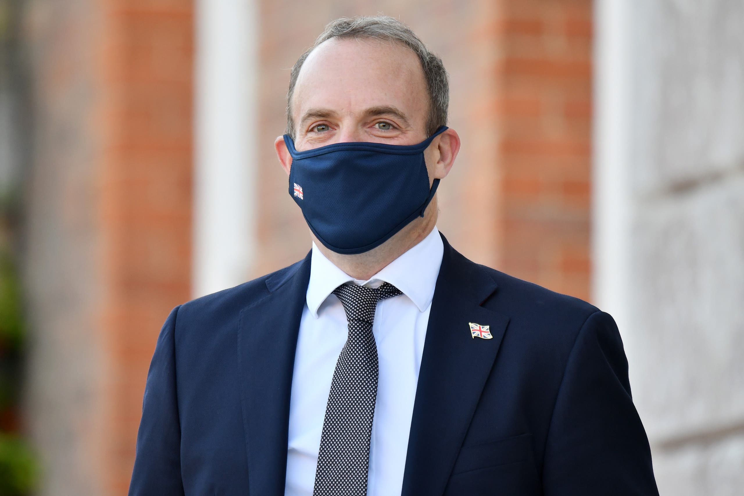 Britain's Foreign Secretary Dominic Raab wearing a protective face mask, waits to greet E3 foreign ministers at Chevening House, Sevenoaks, south of London, on September 10, 2020. The E3 foreign ministers met at the Foreign Secretary's country residence Chevening House.