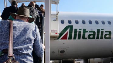 The logo of Italy's flag carrier Alitalia is pictured on an Airbus A320 on June 4, 2019 as passengers board the plane at Rome's Fiumicino airport. (AFP)