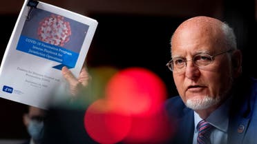 Centers for Disease Control and Prevention Director Dr. Robert Redfield holds up a CDC document that reads COVID-19 Vaccination Program Interim Playbook for Jurisdiction Operations. (Reuters)
