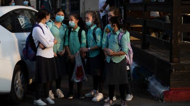 Ultra-Orthodox school girls wearing face masks amid the coronavirus pandemic wait to cross a street in Beit Shemes, Israel, Tuesday, Sept. 8, 2020. (AP)