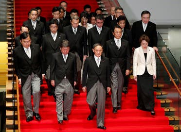 Japan’s Prime Minister Yoshihide Suga (C) leads his cabinet ministers as they prepare for a photo session at Suga’s official residence in Tokyo, Japan, September 16, 2020. (Reuters)