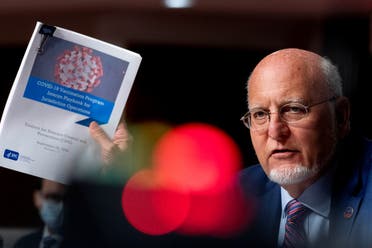 CDC Director Dr. Robert Redfield holds up a CDC document at a Senate Appropriations Subcommittee hearing, Sept. 16, 2020. (Reuters)