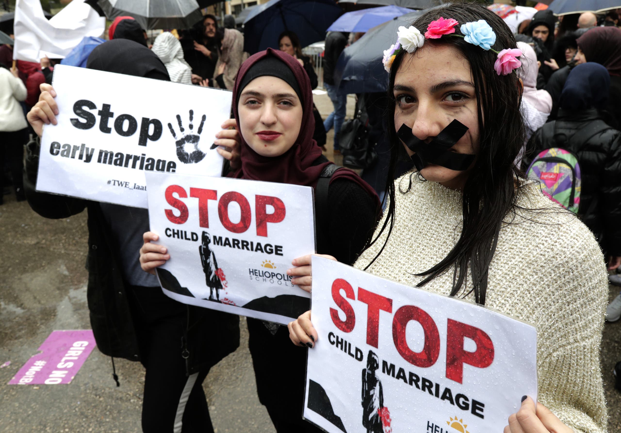 Lebanese women hold placards as they participate in a march against marriage before the age of 18, in the capital Beirut on March 2, 2019. (AFP)