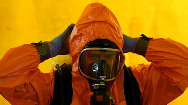 A member of Madrid's SAMUR Ambulance Service prepares to disinfect a colleague, during the coronavirus disease (COVID-19) pandemic, at their headquarters in Madrid, Spain, August 26, 2020. (Reuters)