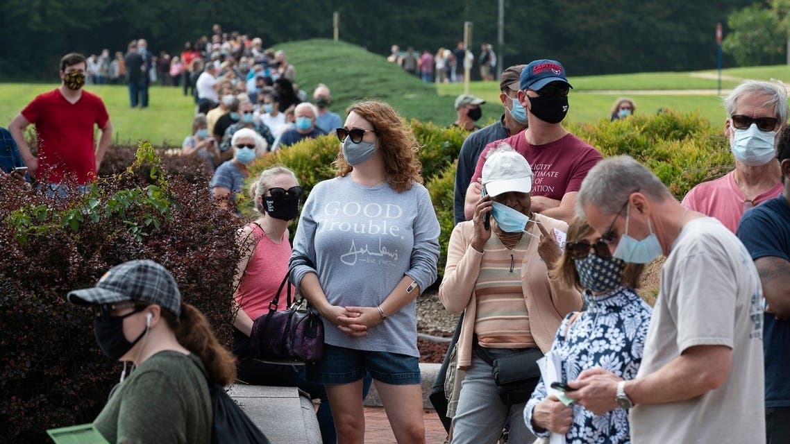 Voters wait in line to cast their ballot at an early voting location in Fairfax, Virginia on Sept. 18, 2020. (AFP)